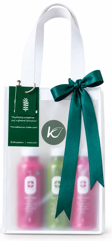 Hampers Kboon: tas bening berpita hijau berisi tiga botol jus